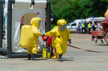 Fireman Wear Hazard Protection Suit Or Bright Yellow Hazmat (hazardous Material) Suits In Hot Zone Tent