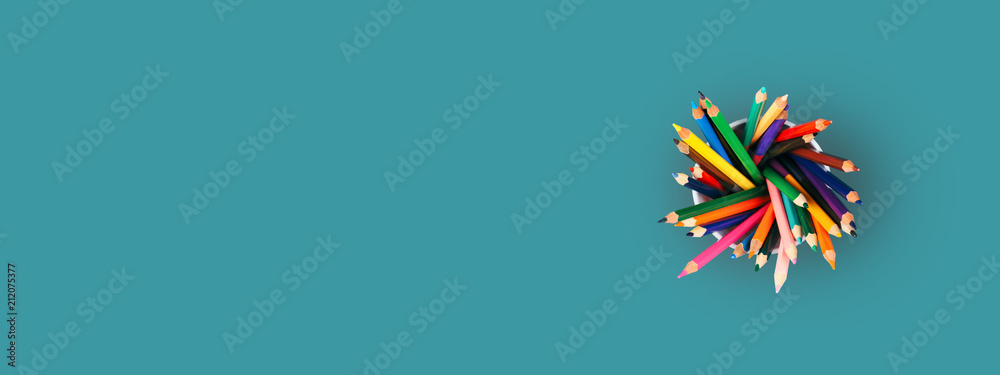 Colored pencils in holder on green background. Top view, banner for site with place for text. - obrazy, fototapety, plakaty 