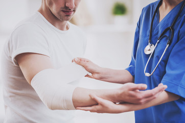 Close up. Doctor Comforting Hand Inury of Patient.