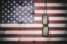 Military Dog Tags On American Flag Background