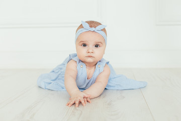 cute baby on white background.close up head shot of a caucasian baby girl, six months old baby in bl