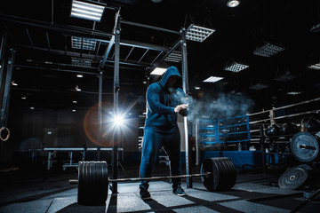 Wall Mural - Strong man working in gym