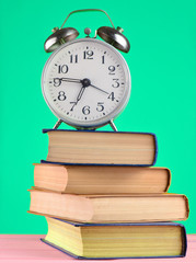 Wall Mural - Alarm clock on top of piles of books