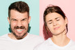 © master1305 - Closeup portrait of young couple, man, woman. One being excited happy smiling, other serious, concerned, unhappy on pink and blue background. Emotion contrasts