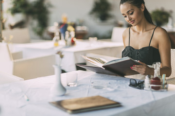 Wall Mural - Beautiful woman ordering from menu