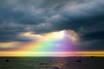 rainbow back dark cloud on sea. concept god bless, wish