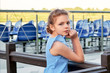 Portrait beautiful caucasian child girl of 9-10 years. Relaxing summer day, outdoors, pier. Kid standing near wooden railing, looks the camera from behind. lifestyle.
