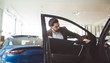 © Wavebreak Media - Handsome salesman examining car