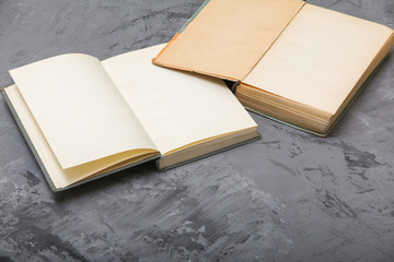 old open books on a gray concrete background