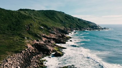 Wall Mural - Aerial view of Brazilian coast. Blue sea with green mountains.