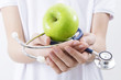 © carballo - hands with stethoscope and green apple, healthy diet concept
