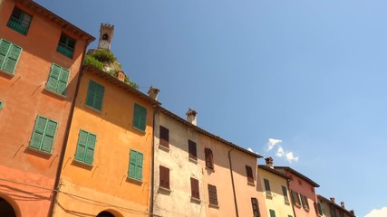 Wall Mural - ancient clock tower overlooking medieval village