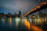 Fototapeta  - The Queensboro Bridge at night, seen from Roosevelt Island in New York City.