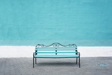 Blue Bench On A Background Of Blue Wall. Front View, Empty Space.