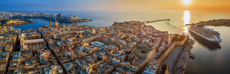 Wall Mural - Valletta, Malta - Aerial panoramic view of Valletta with Mount Carmel church, St.Paul's and St.John's Cathedral, Manoel Island, Fort Manoel, Sliema and cruise ship entering Grand Harbor at sunrise
