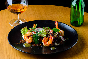 Canvas Print - Appetizing spicy salad with shrimps, radish and sauce on the tab