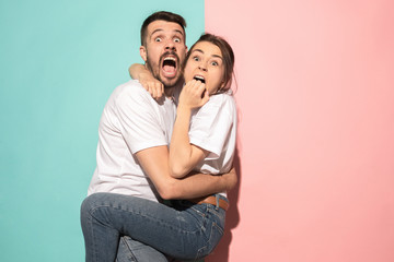 Wall Mural - Portrait of the scared man and woman on pink and blue