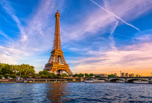 paris eiffel tower and river seine at sunset in paris, france. eiffel tower is one of the most iconi