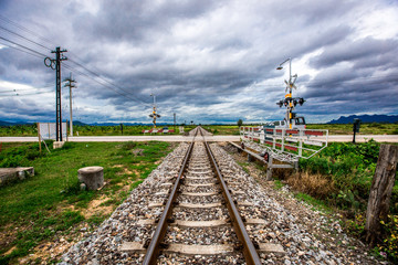 Railroads have barricades and traffic signals to alert when trains pass.