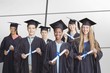 © vectorfusionart - Composite image of portrait of students holding degree