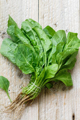 Fresh green organic spinach on an old wooden table. Harvest from the garden. The concept of healthy eating