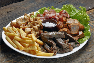 Wall Mural - Snacks with fries, crackers, meat, pork, sausage and babercue sauce