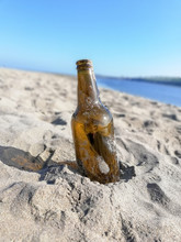 Empty Beer Bottle Washed Up On A Beach