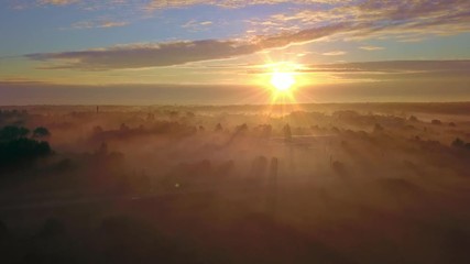 Wall Mural - beautiful aerial shot of thick layer of fog on fields during sunrise with expanse and endless skylin