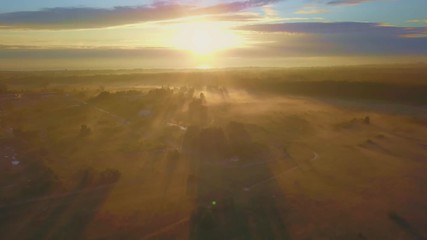 Wall Mural - beautiful aerial shot of thick layer of fog on fields during sunrise with expanse and endless skylin
