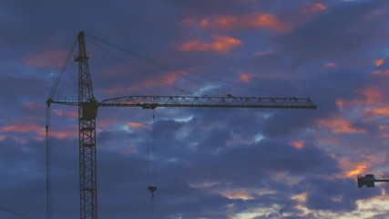 Wall Mural - sunset clouds timelapse with construction cranes on background