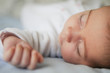© javiindy - Newborn baby girl sleeping on blue sheets