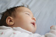© javiindy - Newborn baby girl sleeping on blue sheets