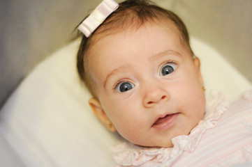 Wall Mural - Little baby girl with surprise expression on her face