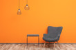 © New Africa - Comfortable armchair and small table against color wall
