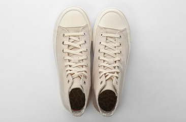 Pair of sneakers on white background, top view