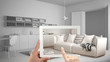 © ArchiVIZ - Augmented reality concept. Hand holding tablet with AR application used to simulate furniture and interior design products in real home, modern living room with kitchen