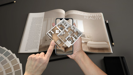 Wall Mural - augmented reality concept. hand holding smartphone with ar application used to simulate 3d pop-up in