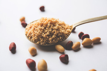 Wall Mural - Crushed peanuts or mungfali powder with whole and roasted groundnut. Served in a bowl over moody background. Selective focus