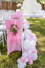 Wall Mural - Green backyard decorated with pink balloons and flowers around chairs and wedding altar