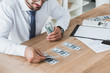 cropped image of business adviser counting dollar banknotes on table in office