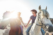 Couple riding horses during sunny day