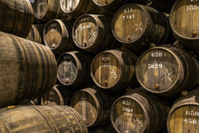 Row Of Wooden Porto Wine Barrels In Wine Cellar Porto, Portugal.