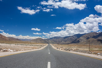 Wall Mural - Emty road vanishing into HImalayas mountains in Ladakh, Northern India. Road trip concept