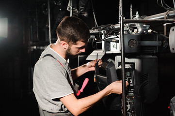 Sticker - The lighting engineer adjusts the lights on the stage.