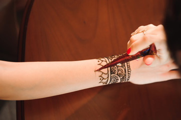 Wall Mural - Drawing process of henna menhdi ornament on woman's hand