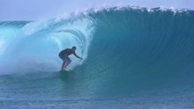 SLOW MOTION, CLOSE UP: Big Emerald Wave Curls Over The Pro Photographer Shooting The Extreme Surfer Carving Epic Tube Waves In Tahiti. Underwater Filmmaker Standing In Ocean And Filming Surfers.