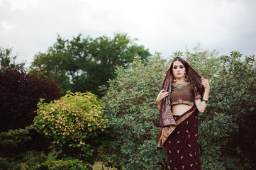 Wall Mural - Portrait of beautiful indian girl . Young hindu woman model with tatoo mehndi and kundan jewelry.