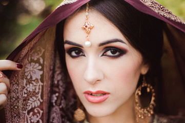 Wall Mural - Portrait of beautiful indian girl . Young hindu woman model with tatoo mehndi and kundan jewelry.