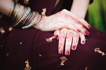 Wall Mural - Mehndi covers hands of Indian woman