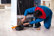 © Elnur - Man repairing fridge with customer
